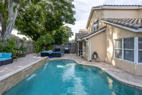 a view of a house with backyard and sitting area