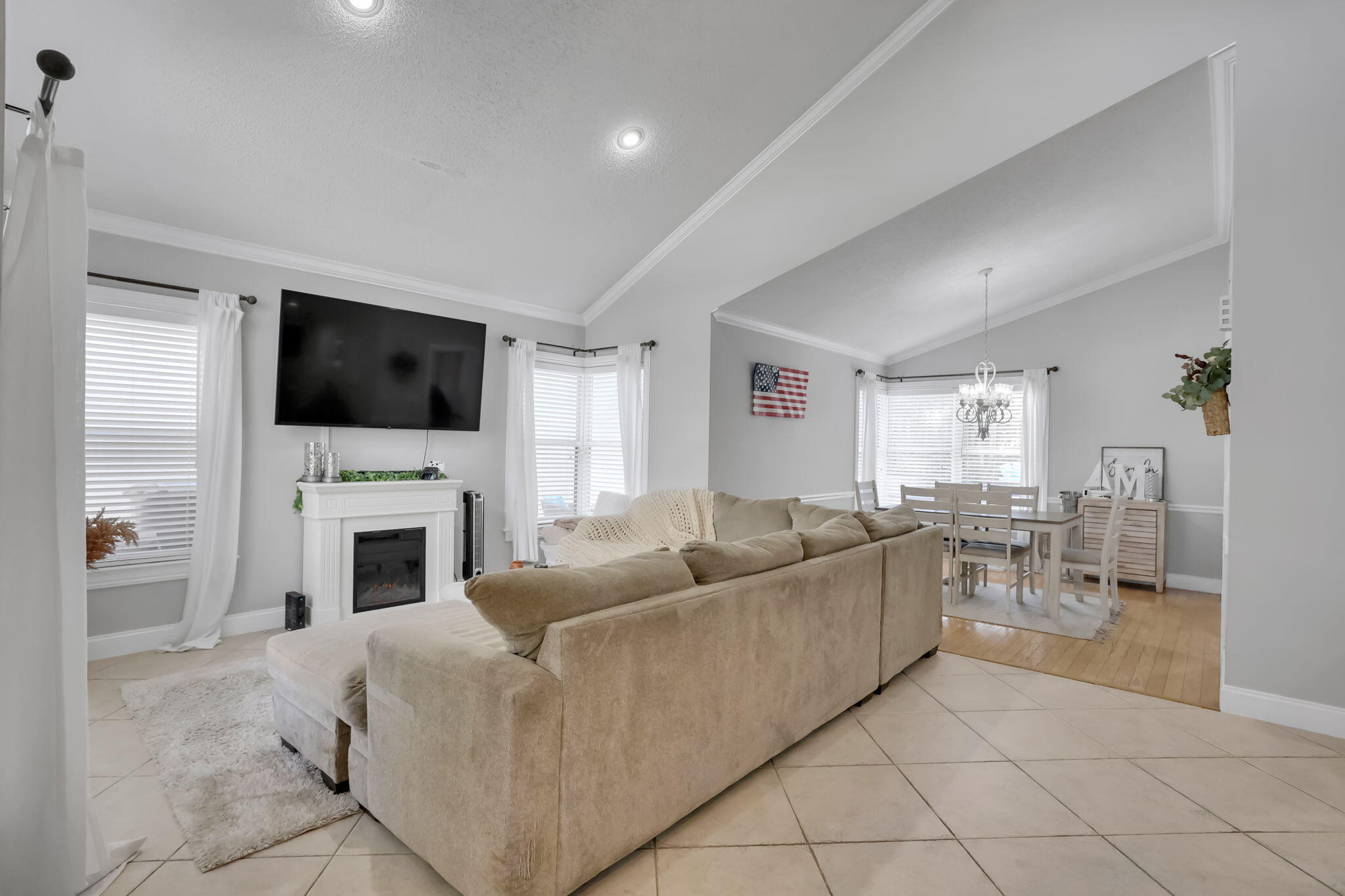 7424 Ashley Shores Circle Lake Worth, FL 33467 - Photo 5 of 33 a living room with furniture a fireplace and a flat screen tv