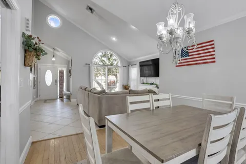 a view of a dining room with furniture and chandelier