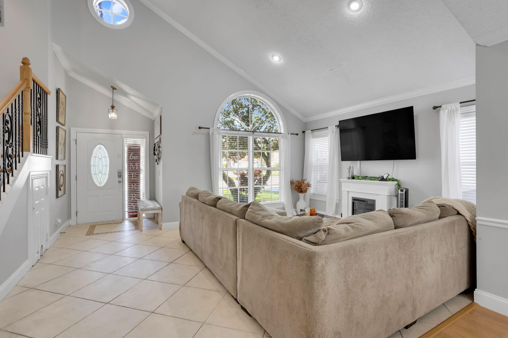 7424 Ashley Shores Circle Lake Worth, FL 33467 - Photo 7 of 33 a living room with furniture a flat screen tv and a large window