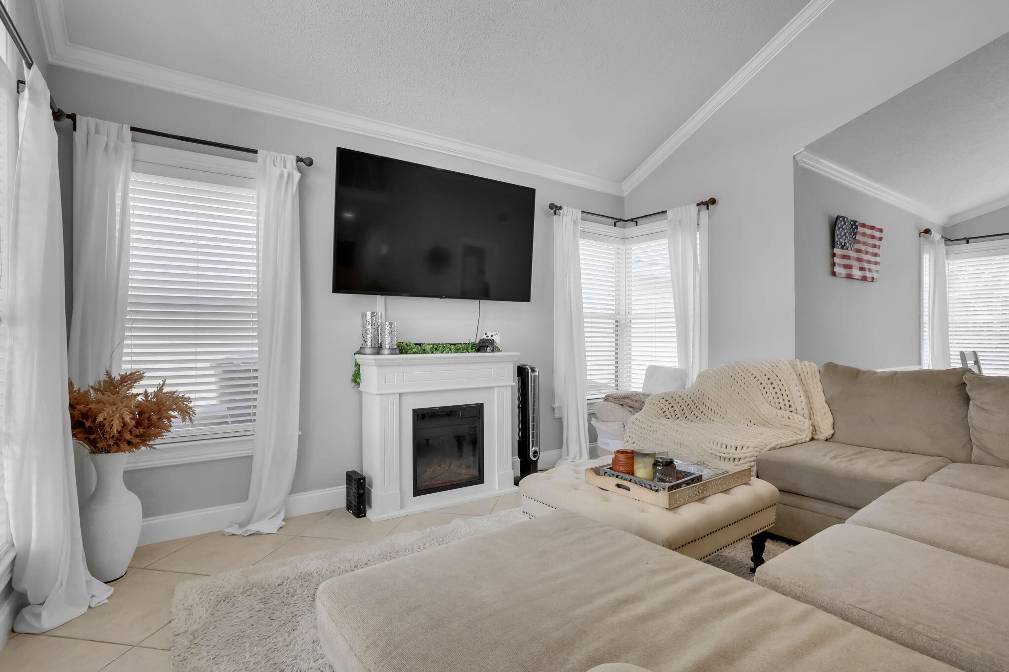 7424 Ashley Shores Circle Lake Worth, FL 33467 - Photo 8 of 33 a living room with furniture a flat screen tv and a fireplace