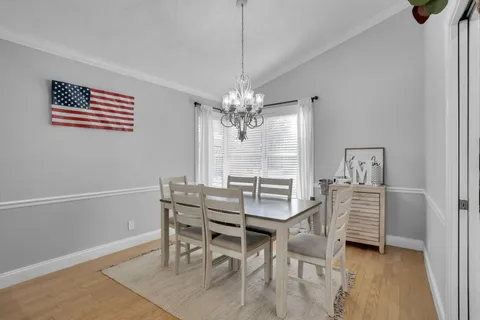 a view of a dining room with furniture and chandelier