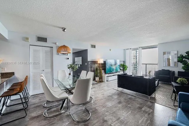 a dining room with furniture and wooden floor