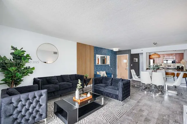 a living room with furniture potted plant and glass windows