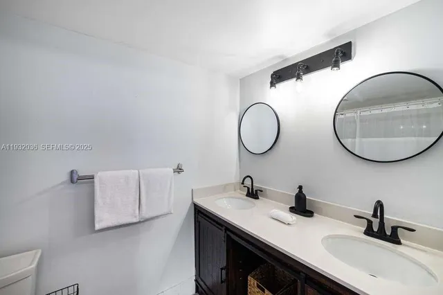 a bathroom with a double vanity sink and a mirror