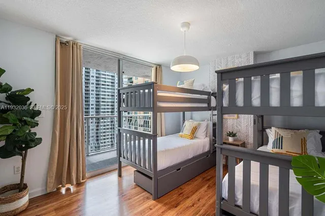 a bedroom with furniture and wooden floor