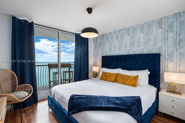 a bedroom with a bed and a large window