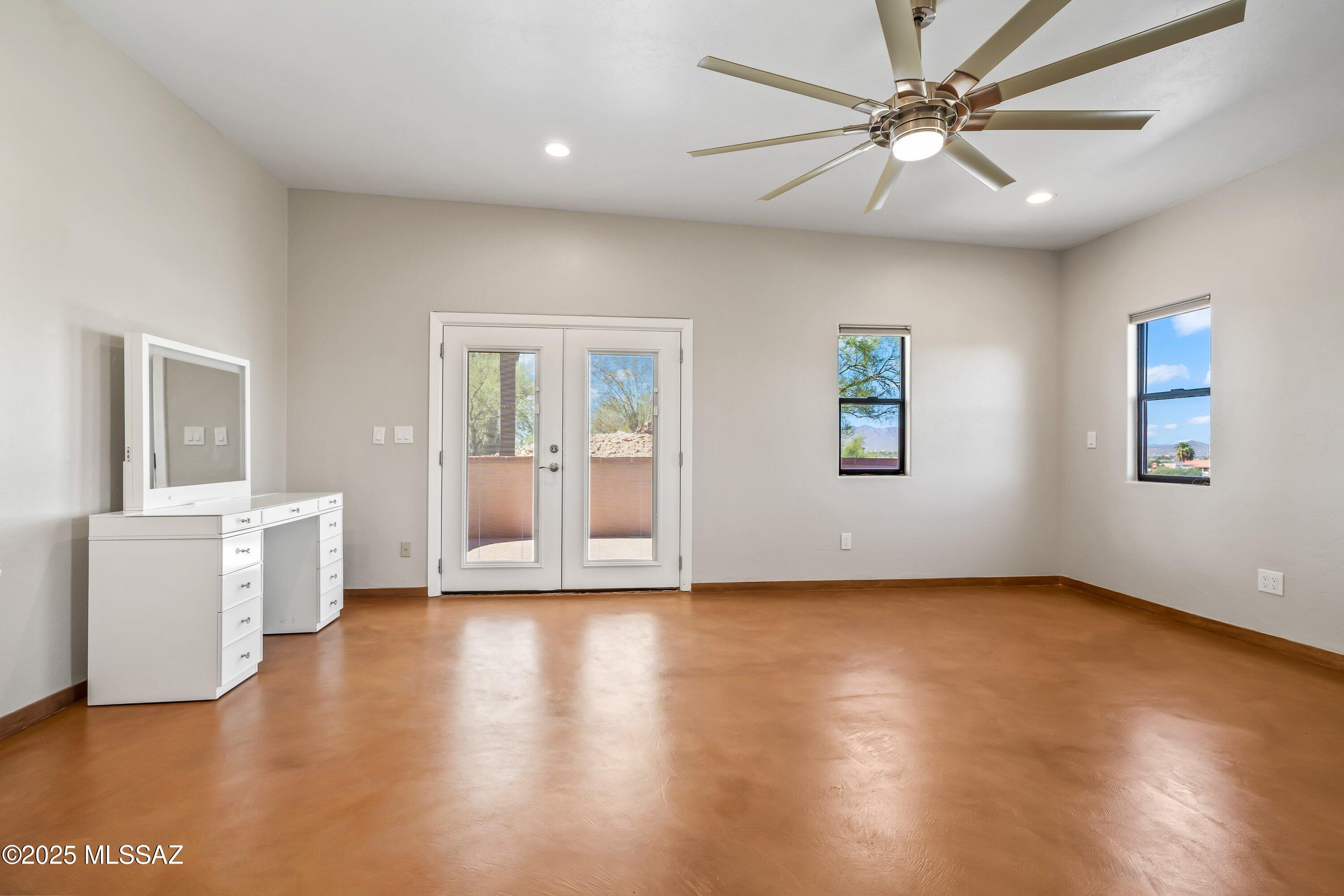30 West Stone Loop Tucson, AZ 85704 - Photo 7 of 26 a view of an empty room with a window and wooden floor