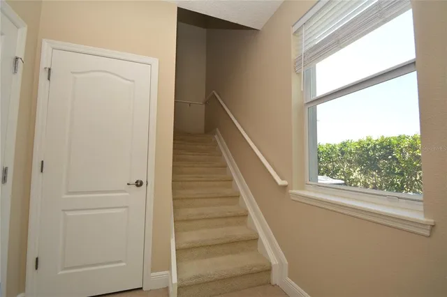 a view of a hallway with wooden floor and entryway