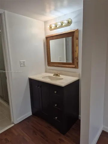 a bathroom with a sink vanity and mirror