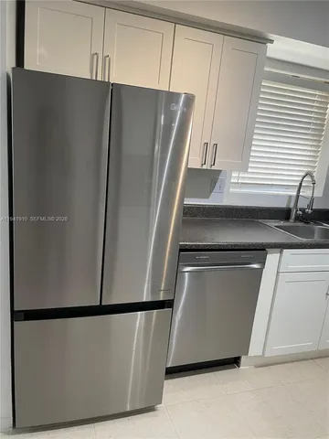 a white refrigerator freezer sitting in a kitchen