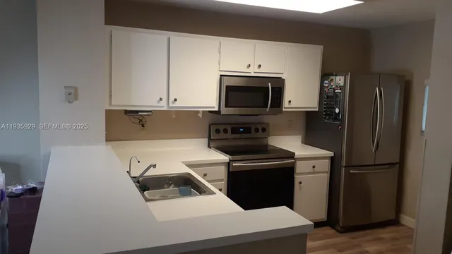 a kitchen with a sink a stove and refrigerator
