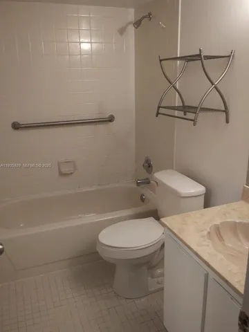 a white toilet sitting next to a bath tub