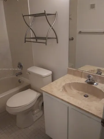 a white toilet sitting next to a bathroom sink