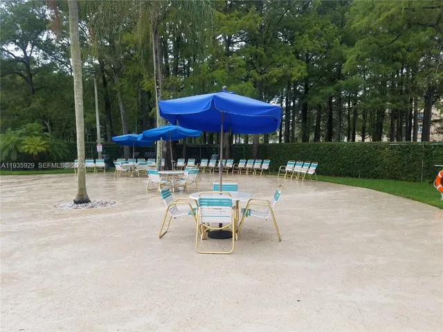 a view of patio with chairs and tables