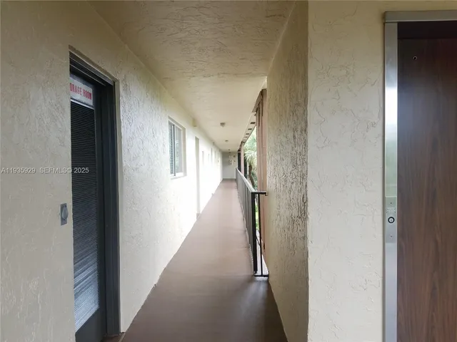 a view of a hallway with the wooden floor