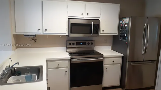 a kitchen with a stove and a microwave