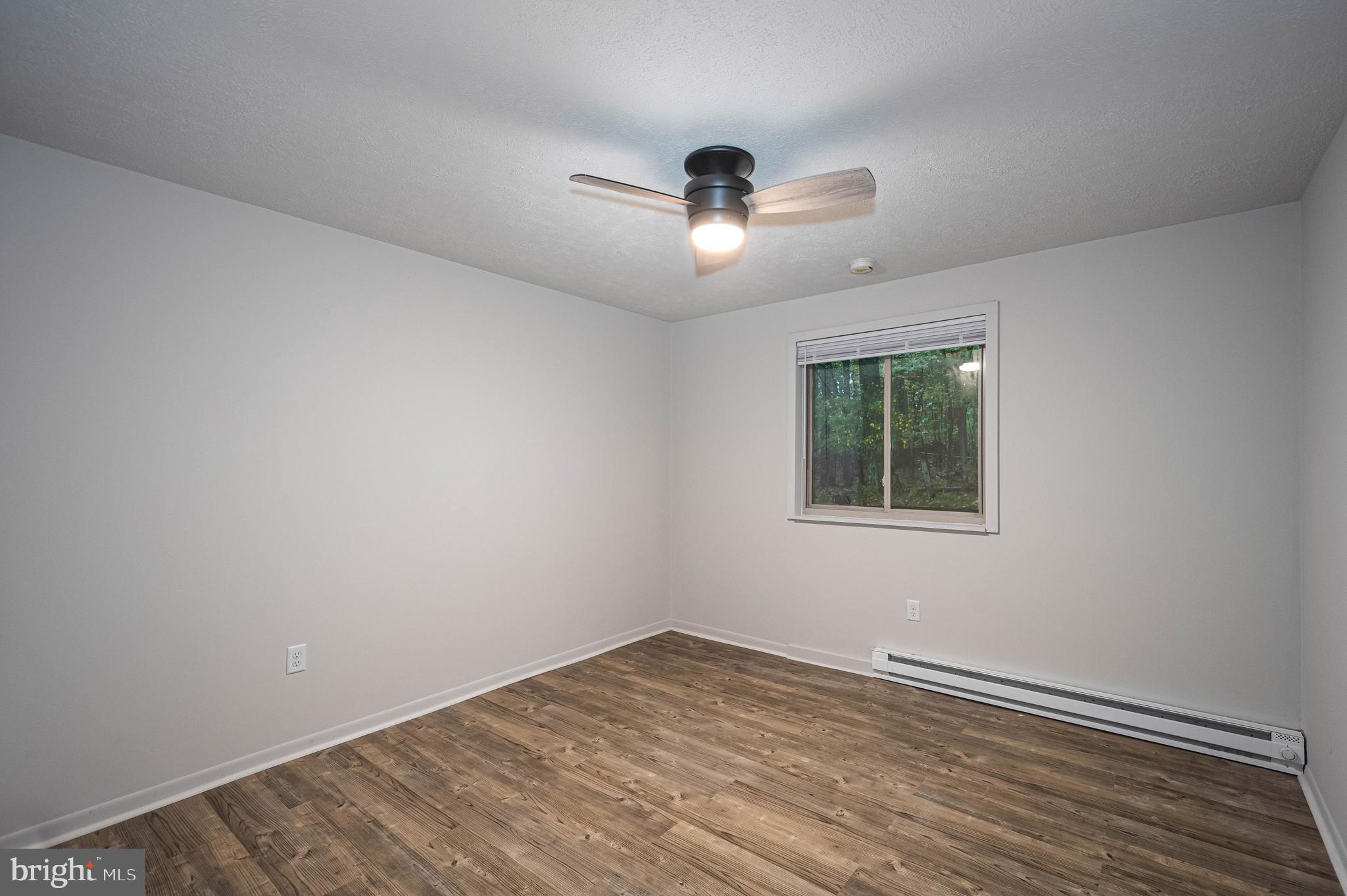 1724 Mosser Road, Unit 1 McHenry, MD 21541 - Photo 14 of 24 a view of empty room with wooden floor and fan