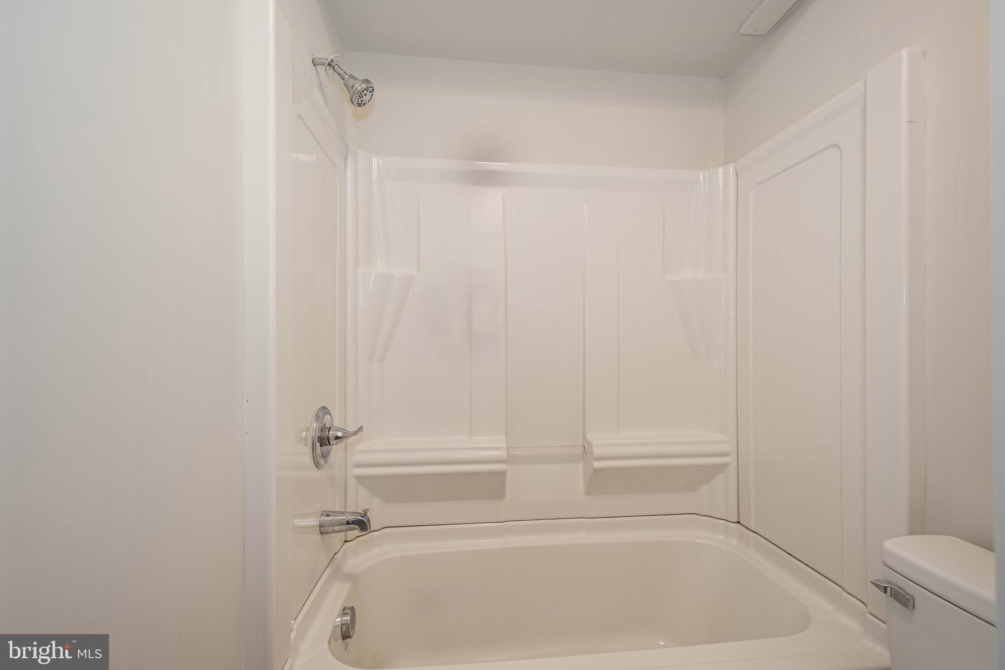 1724 Mosser Road, Unit 1 McHenry, MD 21541 - Photo 15 of 24 a bathroom with a white bath tub