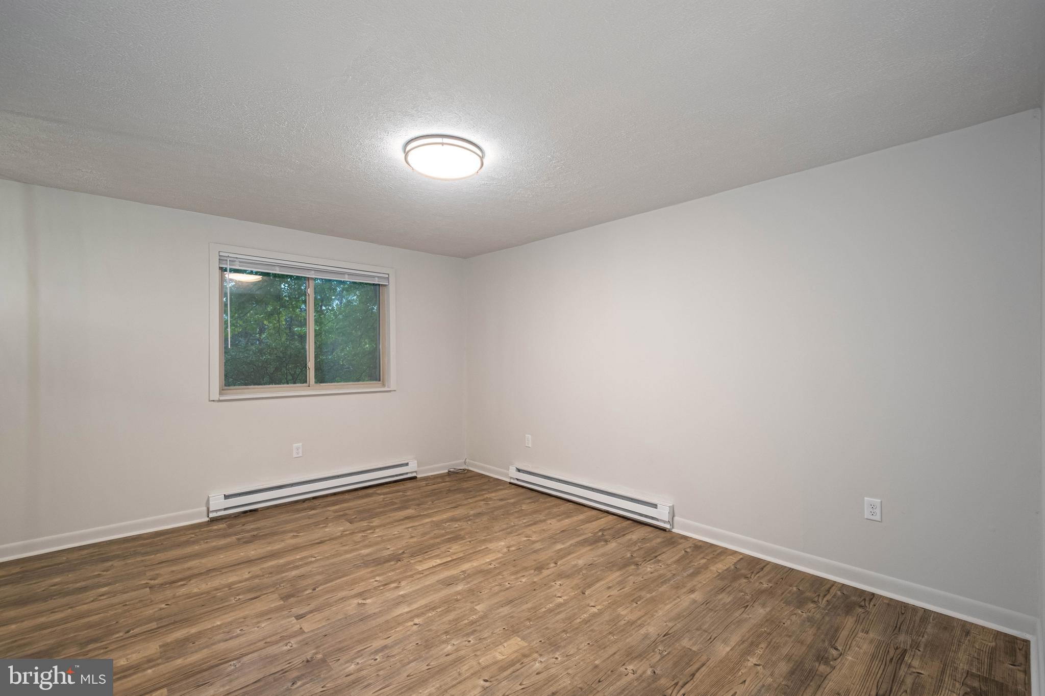 1724 Mosser Road, Unit 1 McHenry, MD 21541 - Photo 4 of 24 wooden floor in an empty room with a window