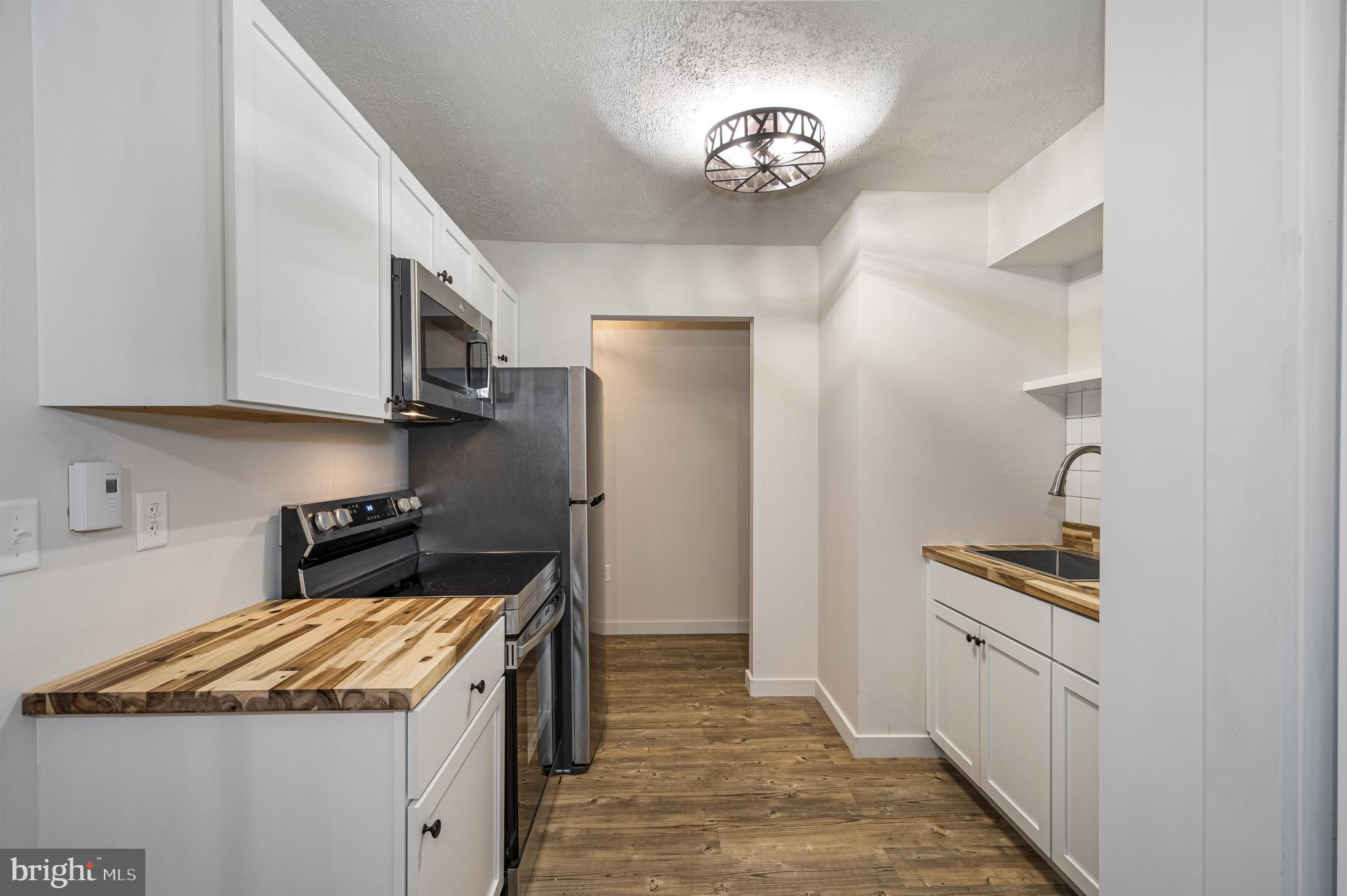 1724 Mosser Road, Unit 1 McHenry, MD 21541 - Photo 7 of 24 a kitchen that has a lot of cabinets in it