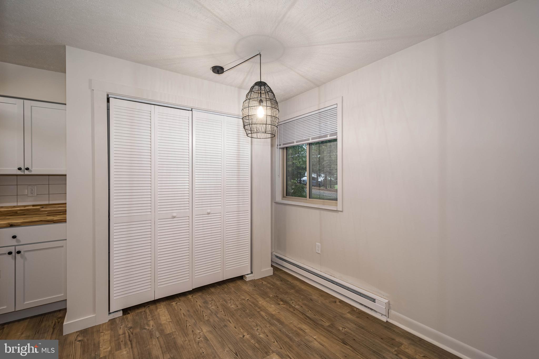 1724 Mosser Road, Unit 1 McHenry, MD 21541 - Photo 8 of 24 an empty room with wooden floor cabinet and windows