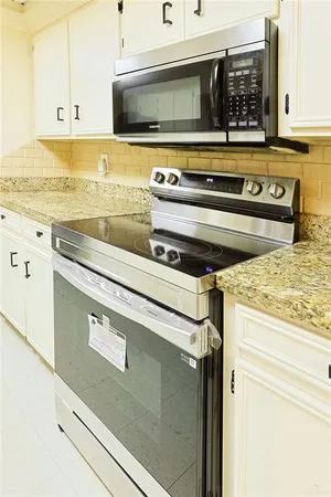 a stove top oven sitting inside of a kitchen