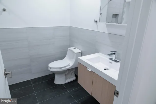 a bathroom with a toilet sink and mirror
