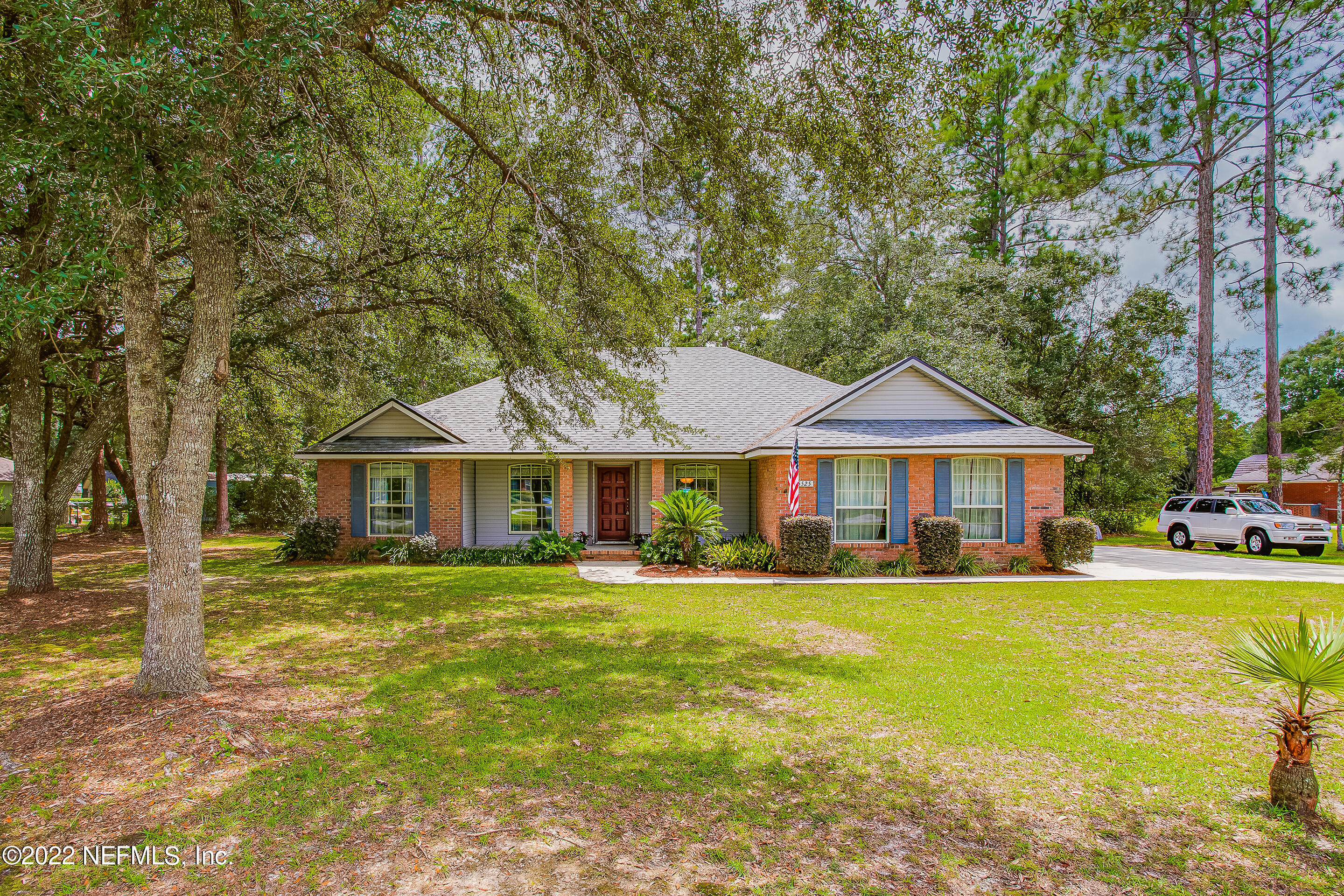 55525 Deer Run Road Callahan, FL 32011 - Photo 1 of 31 a front view of a house with a garden