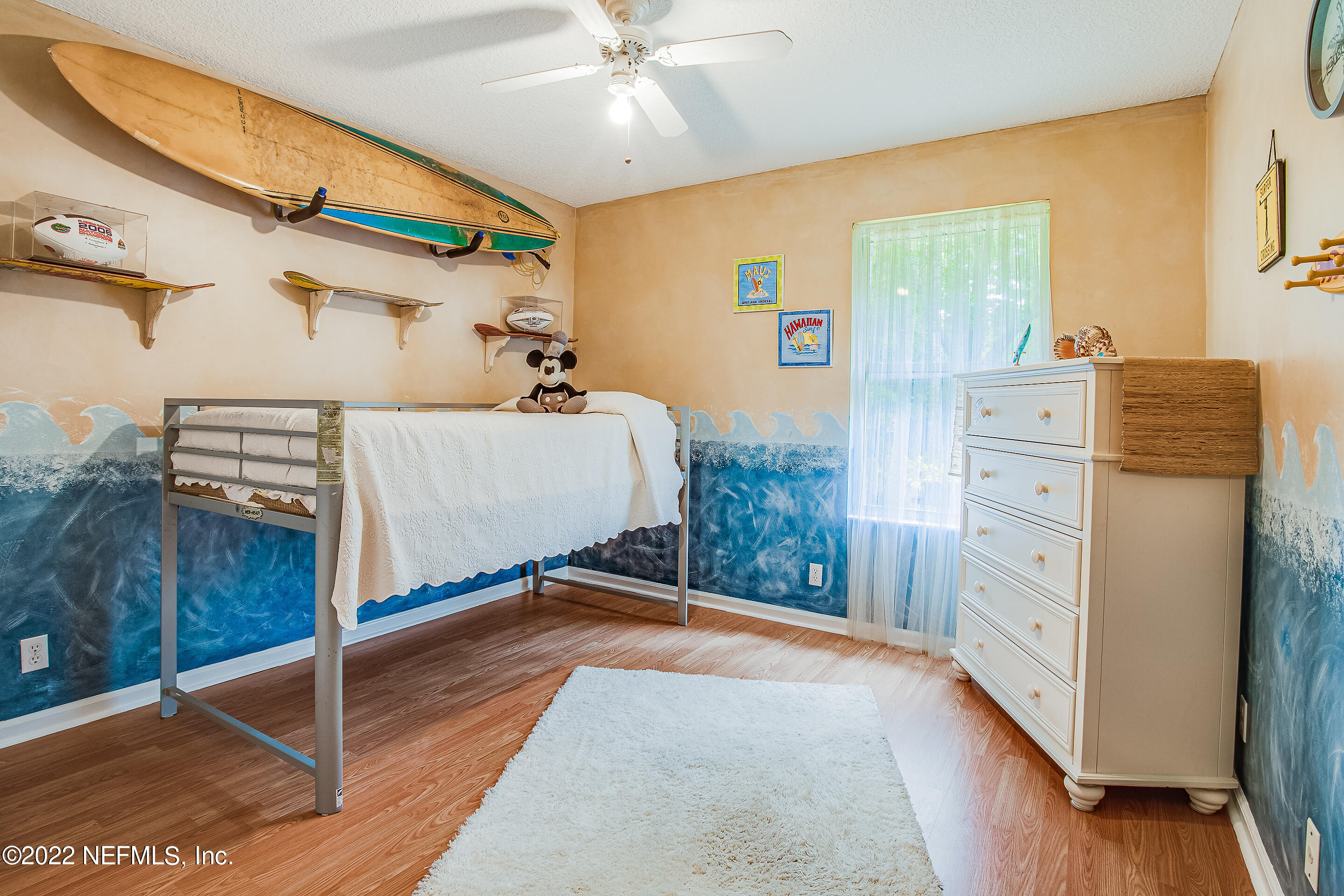 55525 Deer Run Road Callahan, FL 32011 - Photo 19 of 31 a spacious bedroom with a bed and a chandelier