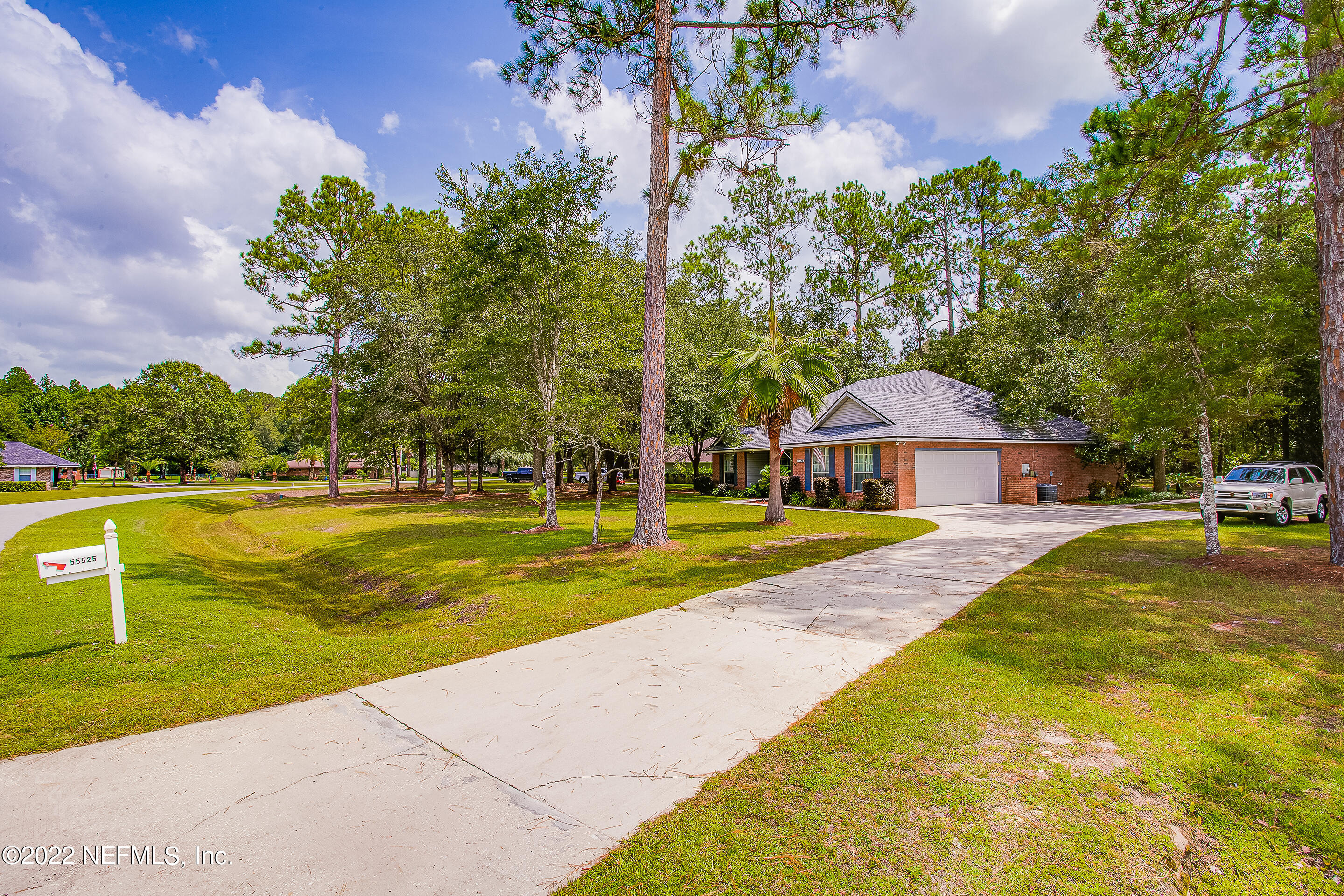55525 Deer Run Road Callahan, FL 32011 - Photo 3 of 31 a view of swimming pool with lawn chairs and plants