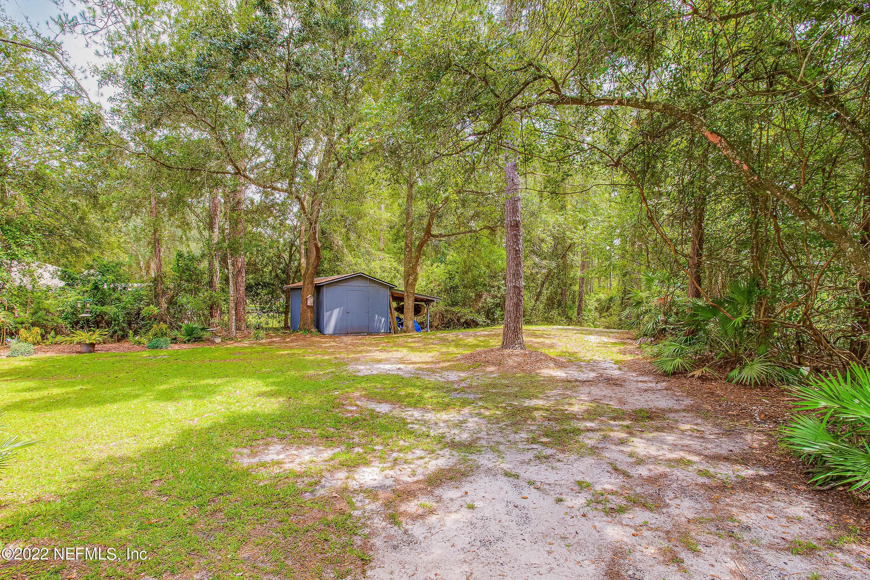 55525 Deer Run Road Callahan, FL 32011 - Photo 31 of 31 a backyard of a house with trees and entertaining space