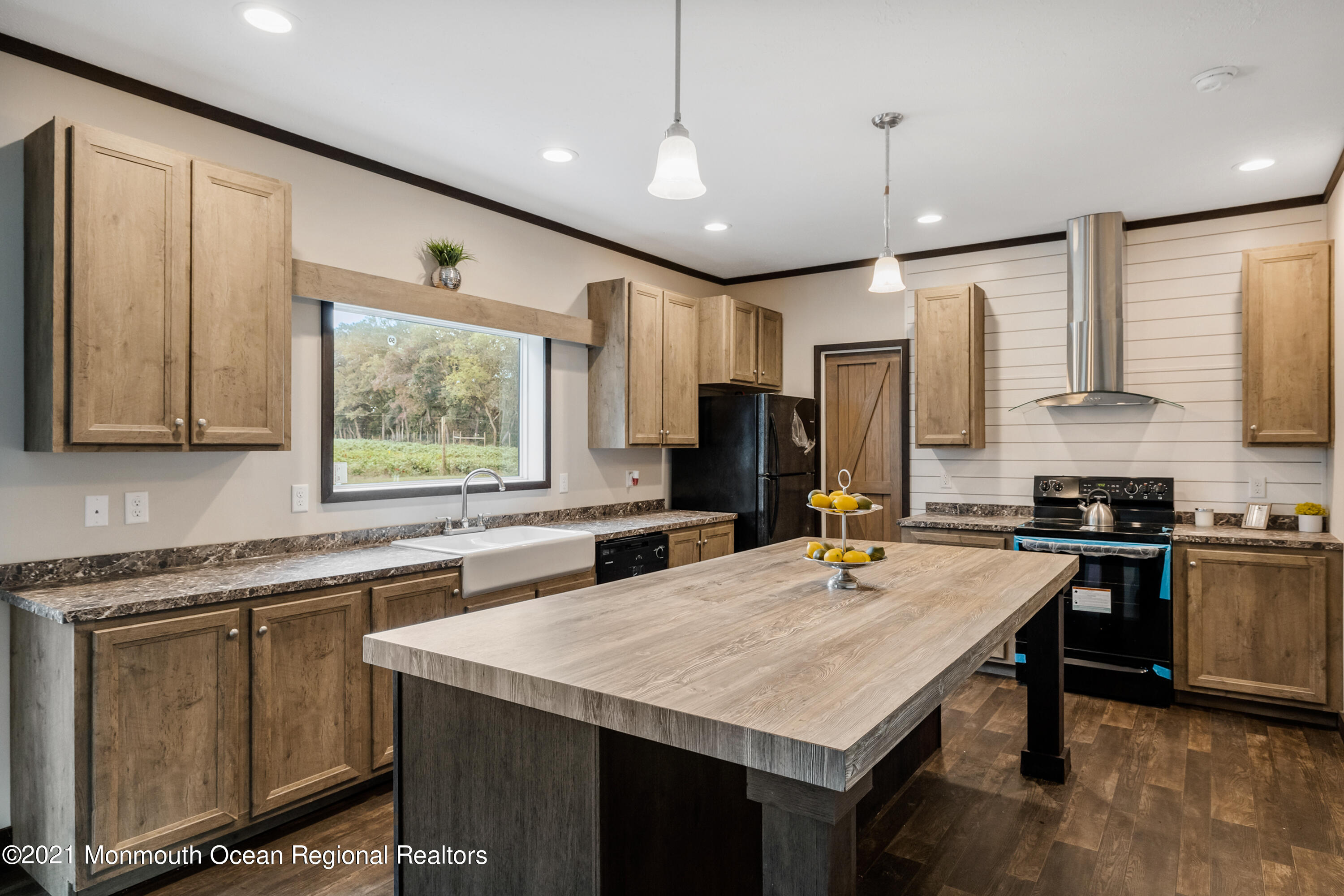 296 Trenton Lakewood Road Cream Ridge, NJ 08514 - Photo 2 of 35 a kitchen with a stove a sink dishwasher a kitchen island with wooden cabinets and chairs