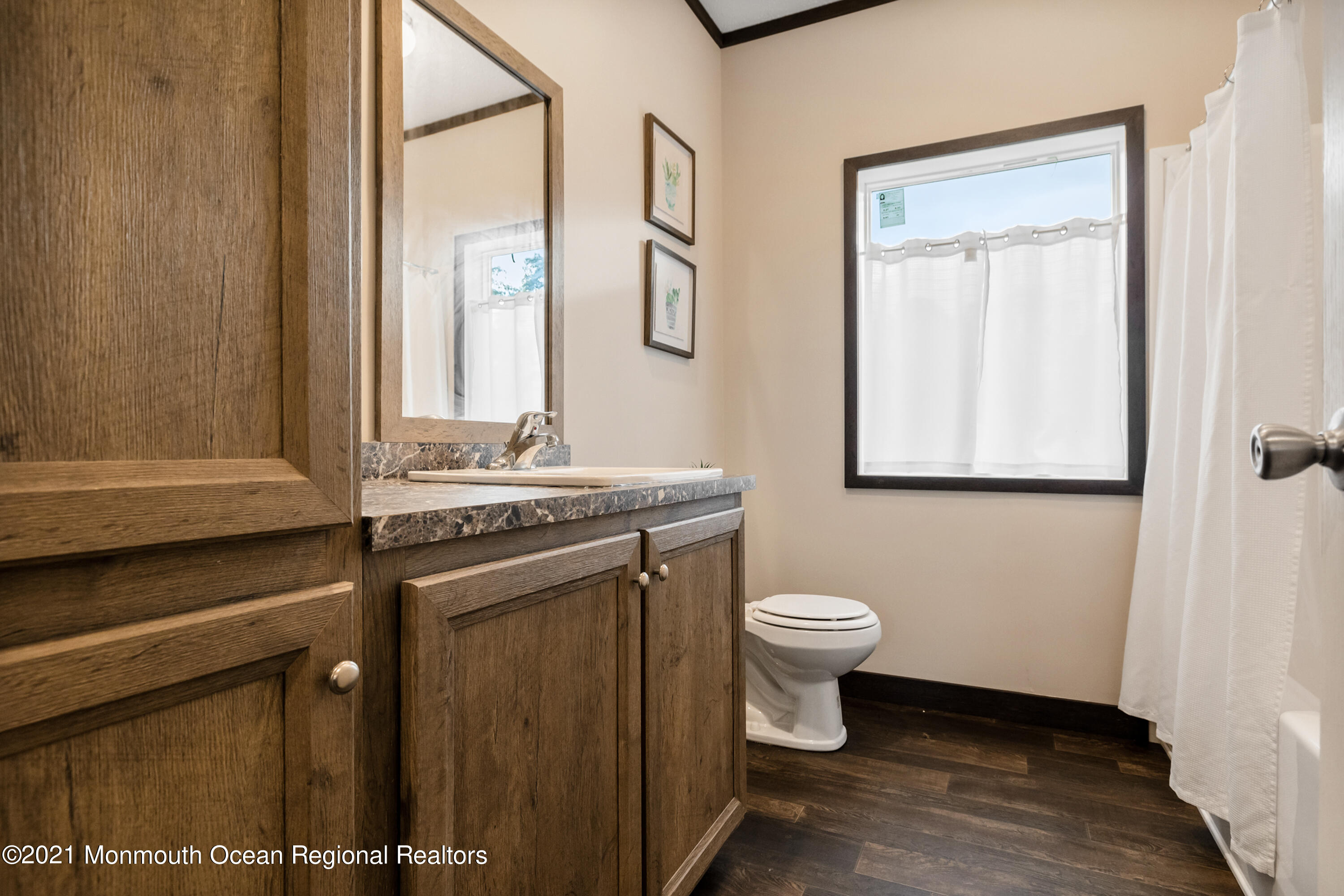 296 Trenton Lakewood Road Cream Ridge, NJ 08514 - Photo 22 of 35 a bathroom with a granite countertop toilet a sink and a mirror