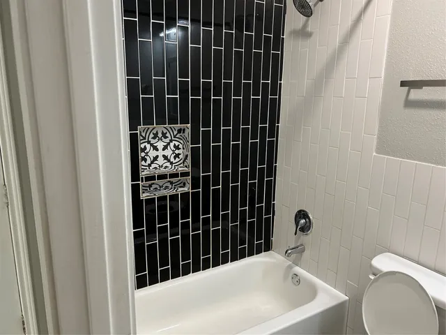 a bathroom with a bathtub and shower