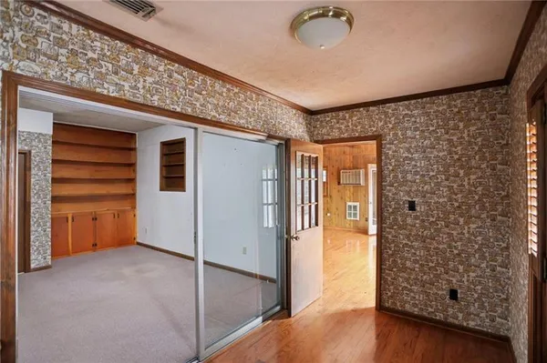 a view of a porch with wooden floor and iron stairs