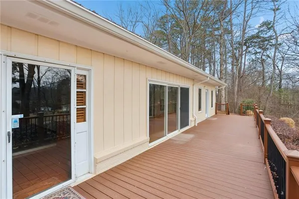 a front view of a house with a yard and trees