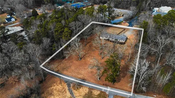 a view of a small park with large trees