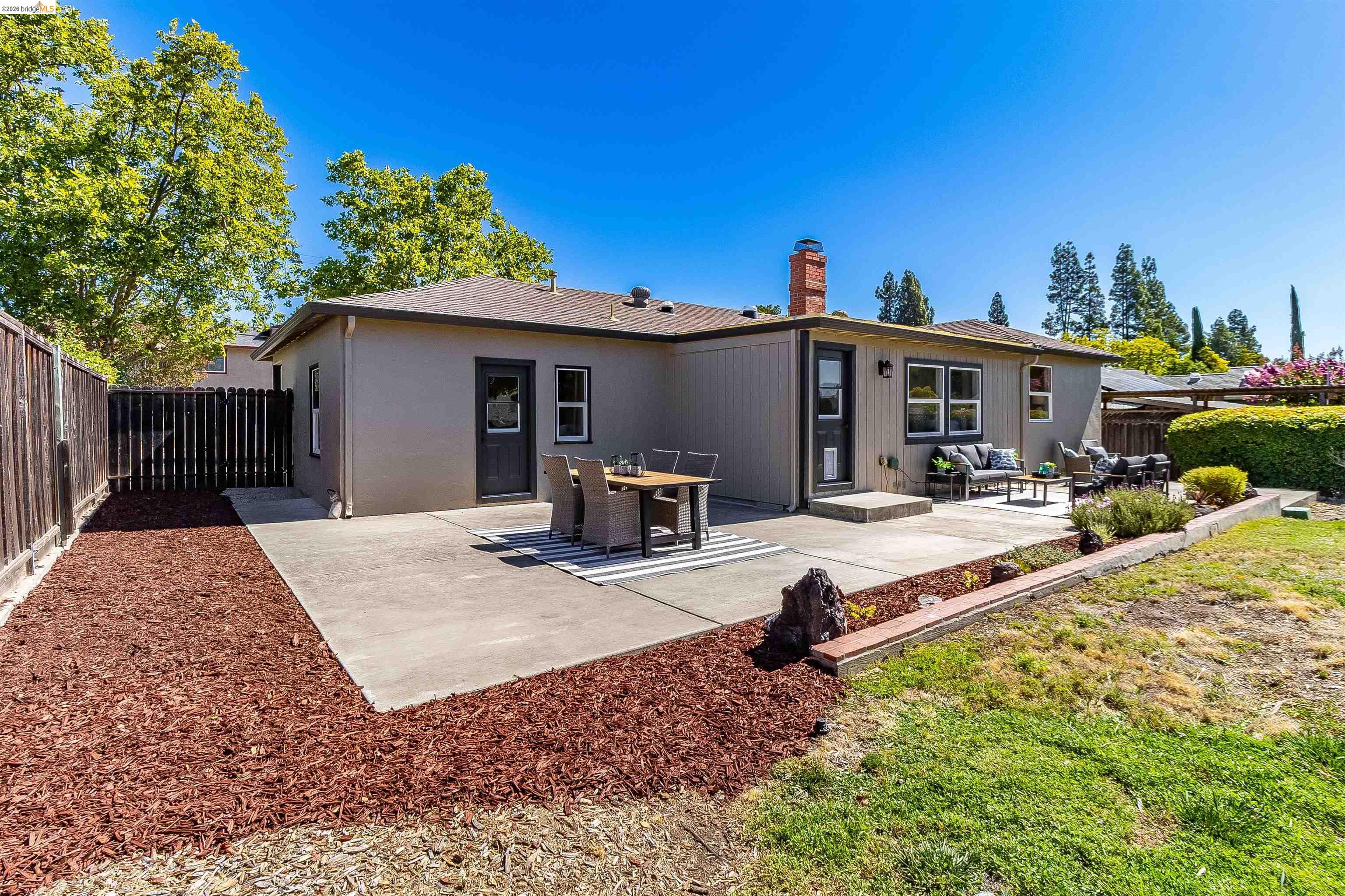 346 Valley View Road Pleasant Hill, CA 94523 - Photo 42 of 57 Rear exterior featuring a concrete patio, wood fencing, and a raised planter bed