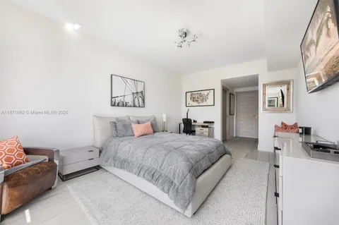 a bedroom with a bed and a view of bathroom