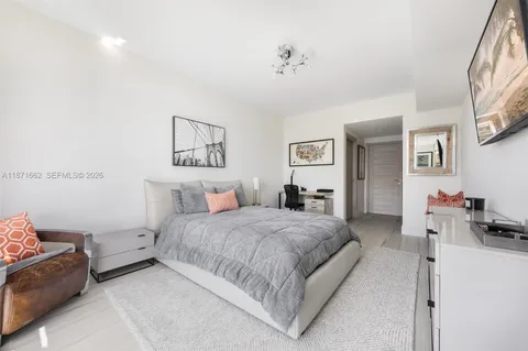 a bedroom with a bed and a view of bathroom