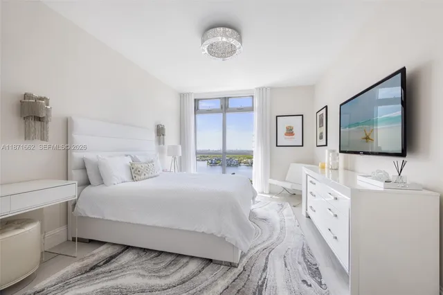 a bedroom with a bed and a flat screen tv