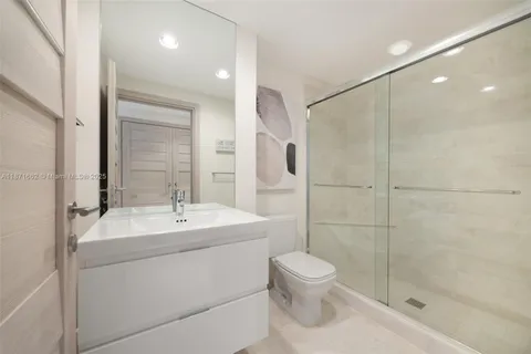 a bathroom with a toilet sink and shower