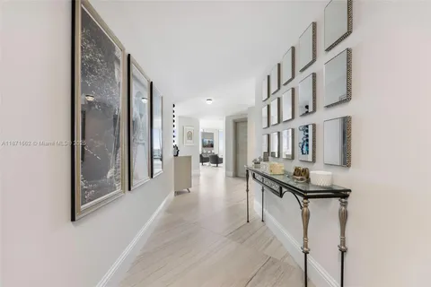 a view of a hallway with a dining table chairs