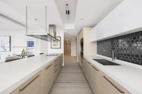 a view of kitchen with stainless steel appliances kitchen island granite countertop a table and chairs in it