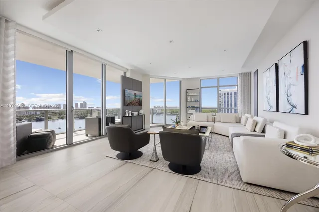 a living room with furniture a large window and kitchen view