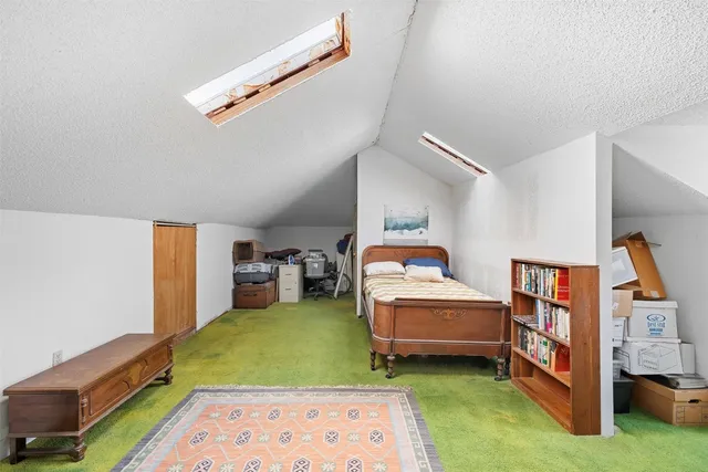 a bedroom with furniture and a rug