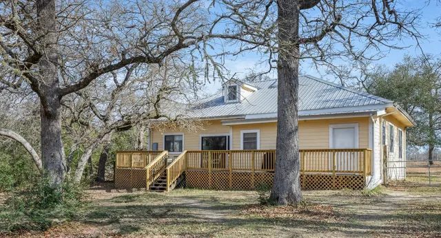 a view of a wooden house with a yard