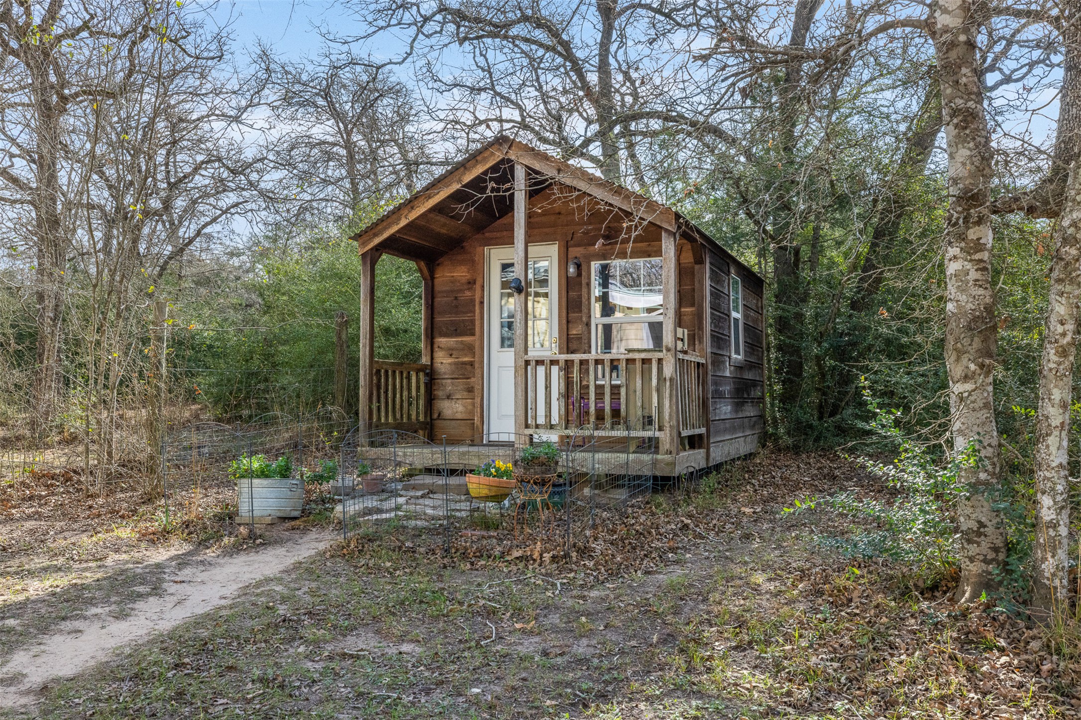 1139 Private Road 7009 Road Lexington, TX 78947 - Photo 21 of 32 a view of a wooden house with a yard