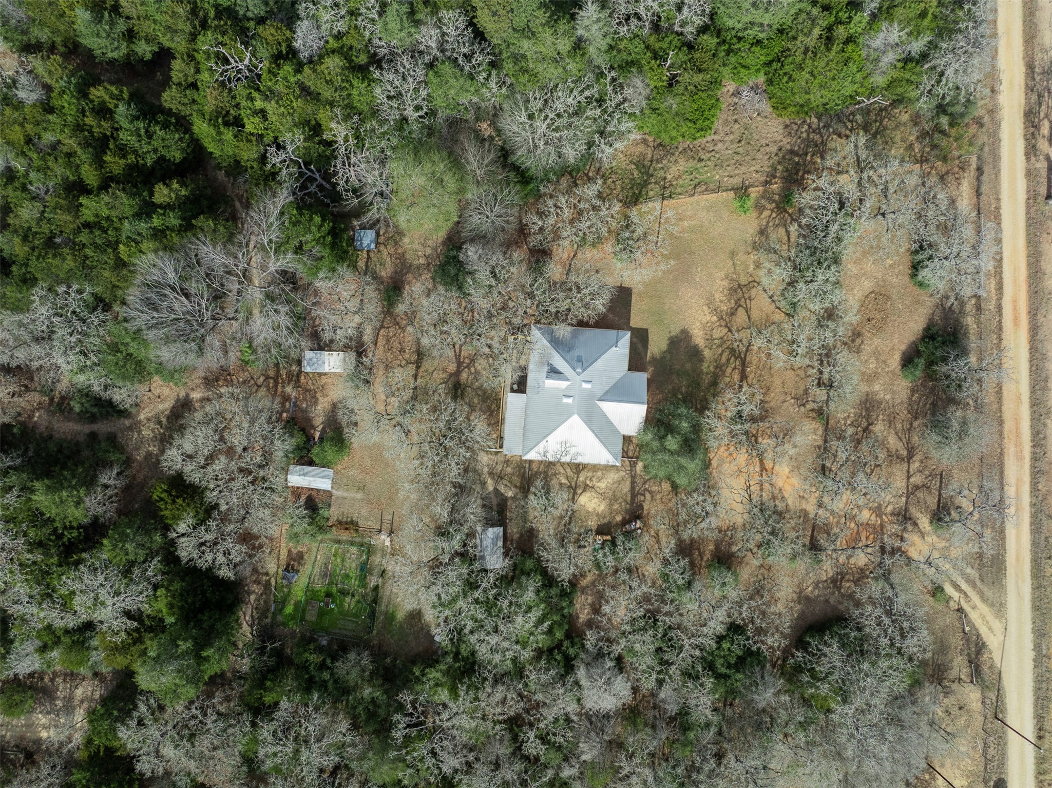 1139 Private Road 7009 Road Lexington, TX 78947 - Photo 27 of 32 a aerial view of a house with a yard and large trees